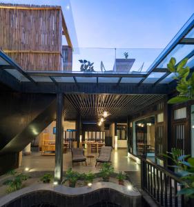 a house with a glass roof with a patio at Lijiang Gemmer Hotel in Lijiang