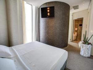 Кровать или кровати в номере Hotel Waldorf- Premier Resort