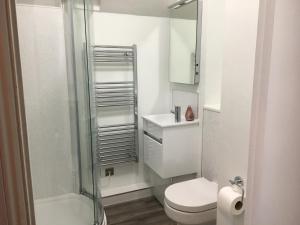 a white bathroom with a toilet and a shower at Avon Guesthouse in Bath