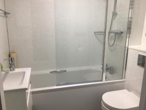 a bathroom with a shower and a toilet and a sink at Avon Guesthouse in Bath