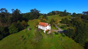 a house on top of a green hill at Posada La Charola in Lamadrid +25 photos