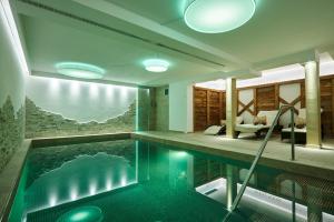 a house with a swimming pool in the middle of it at Hotel Garnì Savoy in Castelrotto