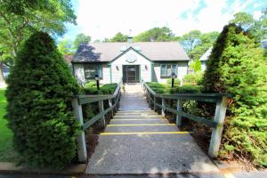 a house with a walkway leading to a house at Cape Cod Holiday Estates, a VRI resort in Mashpee