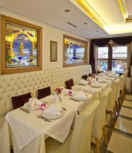 a row of tables in a restaurant with white table cloth at GLK PREMIER Acropol Suites & Spa in Istanbul