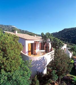a house on top of a hill with trees at U Cantu di i Cardellini in Porto-Vecchio