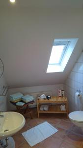 a bathroom with a sink and a skylight at Hotel zur Brücke in Kevelaer