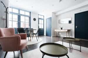 a living room with chairs and a table at The Paddington Studio - Cool & Stylish 1BDR Mews in London