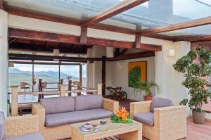 a living room with a couch and chairs and a table at Hotel Tambopaxi in Machachi