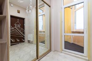 a room with a glass door and a fireplace at Lux Apart Lviv apartments in Lviv