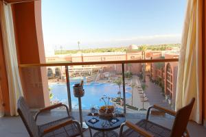 a view of a pool from a hotel room balcony at Savoy Le Grand Hotel Marrakech in Marrakech