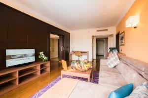 a living room with a couch and a flat screen tv at Savoy Le Grand Hotel Marrakech in Marrakech
