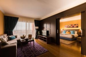 a living room with a bed and a couch at Savoy Le Grand Hotel Marrakech in Marrakech