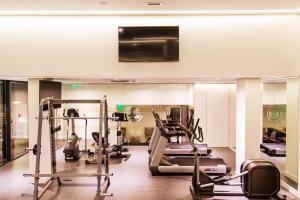 a gym with treadmills and machines in a room at Grand Plaza Hotel Nampula in Nampula