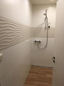 a bathroom with a shower in the corner at Hotel Ahrbella in Bad Neuenahr-Ahrweiler +69 photos