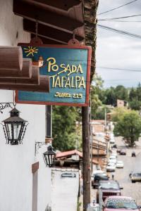 a sign for a restaurant on the side of a street at Hotel Posada Real Tapalpa in Tapalpa