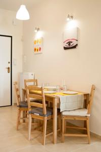 a dining room with a wooden table and chairs at Cozy Bright Apartment in Athens