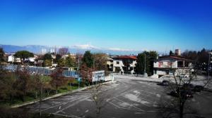 an empty parking lot with mountains in the background at Hotel Dall'Ongaro in Ghirano