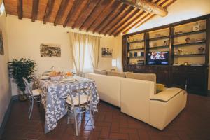 a living room with a table and a couch at Il Cuore Di Lucca in Lucca