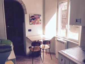 a small kitchen with a table and two chairs at Casa Bertocco in Canale Monterano