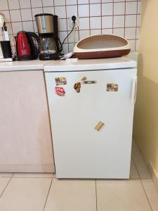 a white refrigerator in a kitchen with a pan on top of it at Studio Anna Veria in Veria