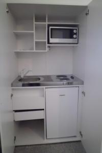 a small kitchen with a sink and a microwave at Appartement St. Peter a Wimberg in Neufelden