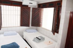 A bed or beds in a room at Hotel Pousada Farol da Praia