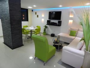 a living room with a couch and a table and chairs at Apartment Lux Bocagrande in Cartagena de Indias