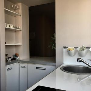 a kitchen with white cabinets and a sink at DELUXE Apartment Newsky with terrace in Belgrade +19 photos