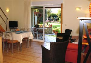 a living room with a table and chairs and a couch at Duplex Playa de Rons in O Grove