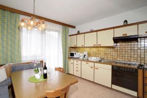 a kitchen with a table and a dining room at Appartment Sonnenschein in Uttendorf +45 photos