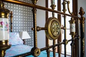 a close up of a bed with a gold frame at Luxury apartment - Fort Chambray in Għajnsielem +44 photos