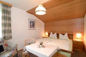 a bedroom with a bed and a table in a room at Appartment Sonnenschein in Uttendorf