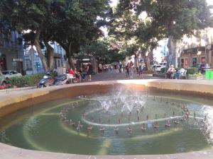 a fountain in a city with people sitting around it at Lalas Ramblas Estudio Santa Cruz Tenerife in Santa Cruz de Tenerife