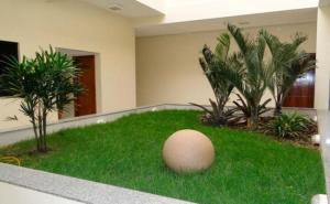 a large egg sitting on the grass in a building at Hotel Cambui in Seabra