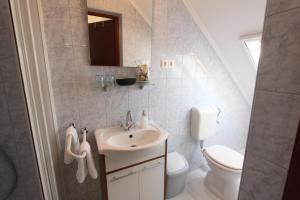 a bathroom with a sink and a toilet at Sorompó Vendégház in Balatonkenese +90 photos