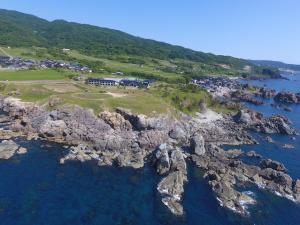an aerial view of a rocky island in the ocean at Hotel Familio Sadoaikawa in Sado
