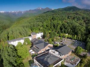 an aerial view of a building in the middle of a mountain at Azumino Hotaka View Hotel in Azumino