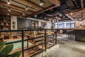 a restaurant with wooden tables and a bar at Chengdu Byway Trip Kuanzhai Alley Branch in Chengdu