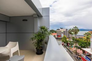 a balcony with a view of the city at Quest Suva in Suva