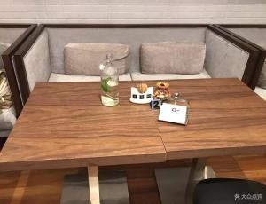 a wooden table in front of a couch at Paco Hotel Gangding Metro Guangzhou-Free Shuttle Bus fir Canton Fair in Guangzhou