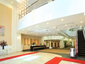 a large lobby with a staircase in a building at Niigata Toei Hotel in Niigata