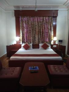 a bedroom with a large bed and a window at Hotel Savoy - Since 1951 in Jaipur