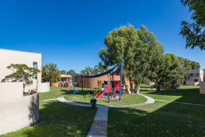 a playground in a park next to a building at Number 72 Kalbarri Riverview Apartments in Kalbarri
