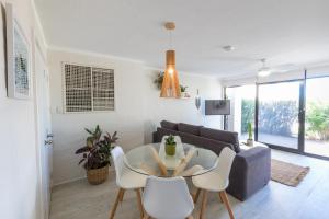 a living room with a table and a couch at Number 72 Kalbarri Riverview Apartments in Kalbarri