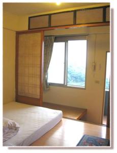 a bedroom with a bunk bed and a window at Jiou Fen Seaside HomeStay in Jiufen