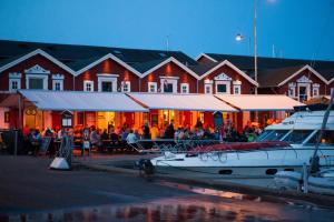 a boat docked in a marina in front of a building at Hotel Hvideklit in Ålbæk