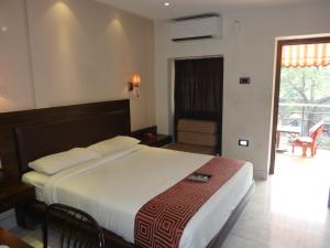 Tempat tidur dalam kamar di Hotel New Bengal