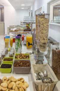 a counter with different types of food on it at Airotel Achaia Beach in Patra