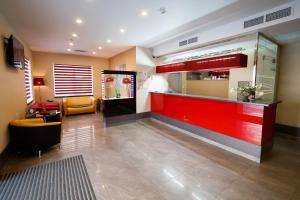 a restaurant with a red counter in a lobby at Avenue Park Hotel in Kurgan
