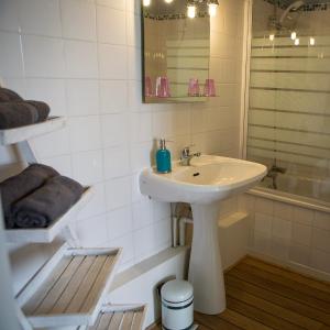 a white bathroom with a sink and a shower at Studios étape du Lac in Bourbon-Lancy +47 photos